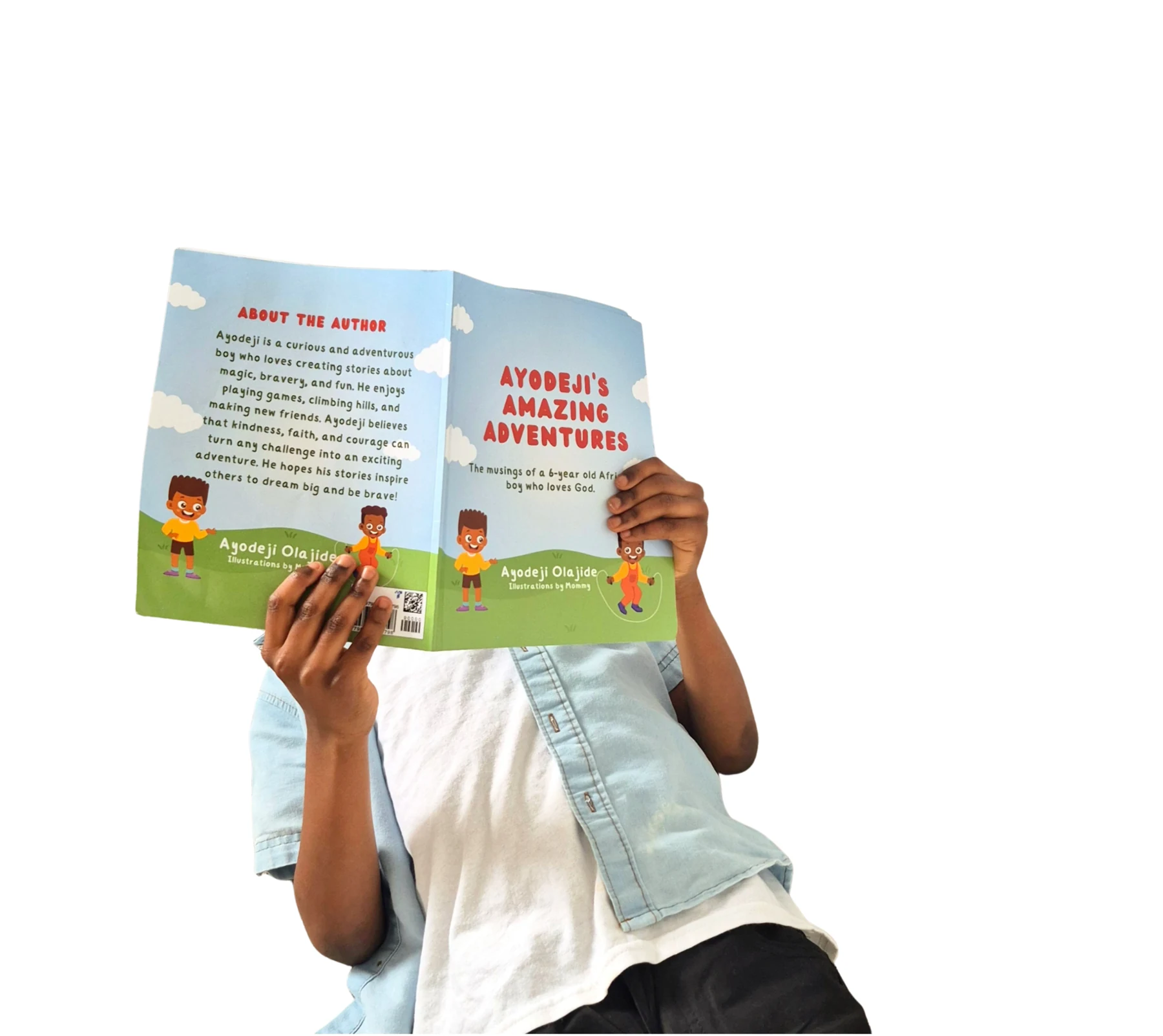 Ayodeji holding his book Ayodeji's Amazing Adventures