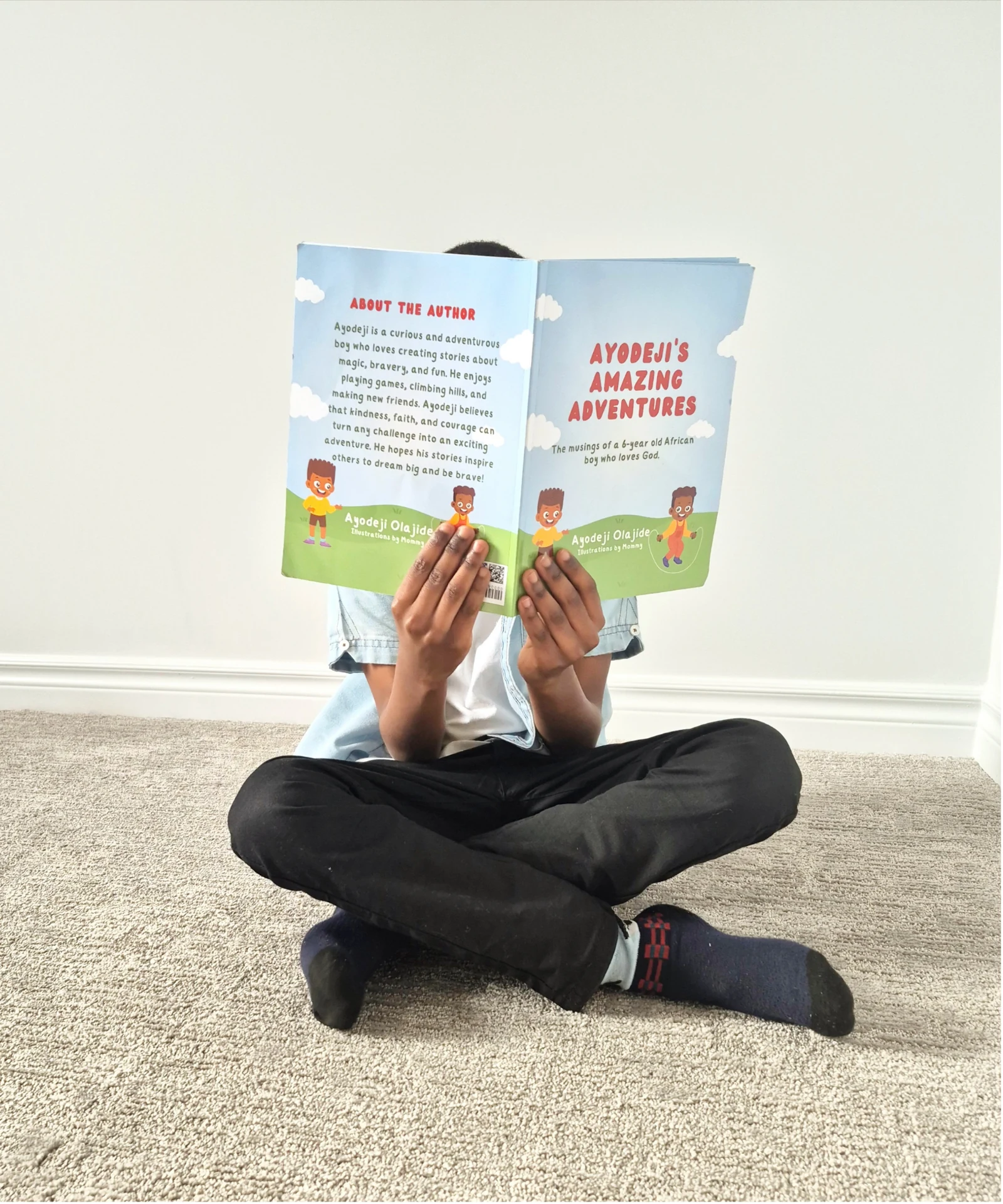 Ayodeji reading one of his books
